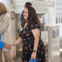 faculty shaking hands while receiving bag